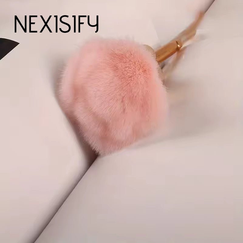 Rose gold makeup brush set with pink rose-themed bristles and gold handles